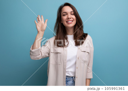 kind smiling 25 year old female person in an elegant casual look on a blue background 105991361