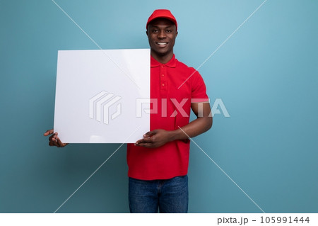 courier american man dressed in a red cap and t-shirt reports the news on a white sheet with a courier american man dressed in a red cap and t-shirt reports the news on a white sheet with a 105991444