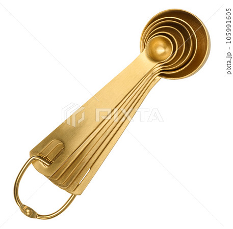 Golden metal measuring spoons for bulk and liquid products on a white isolated background, top view Golden metal measuring spoons for bulk and liquid products on a white isolated background, top view 105991605