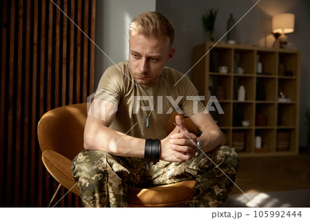 Portrait of military man being deep in thoughts feeling sorrowful Portrait of military man being deep in thoughts feeling sorrowful 105992444