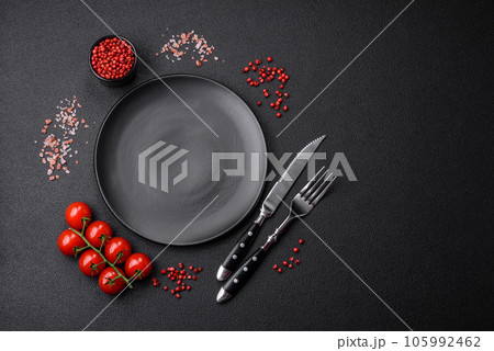 Empty black plate over dark stone background with copy space 105992462