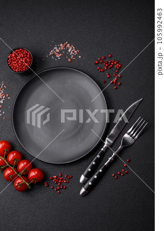 Empty black plate over dark stone background with copy space Empty black plate over dark stone background with copy space 105992463