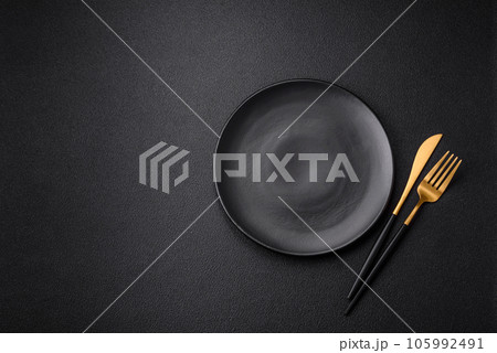 Empty black plate over dark stone background with copy space 105992491