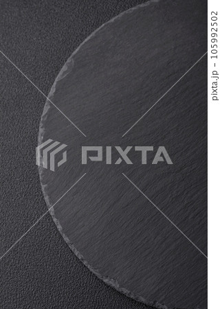 Empty black plate over dark stone background with copy space 105992502