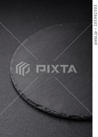 Empty black plate over dark stone background with copy space Empty black plate over dark stone background with copy space 105992503