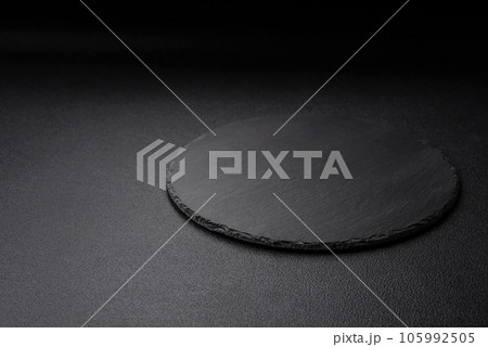 Empty black plate over dark stone background with copy space 105992505