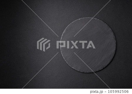 Empty black plate over dark stone background with copy space Empty black plate over dark stone background with copy space 105992506