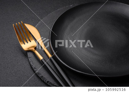 Empty black plate over dark stone background with copy space 105992516