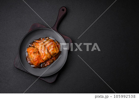 Delicious dolma in tomato sauce with carrots, onions, salt, spices and herbs 105992538