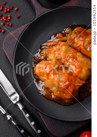 Delicious dolma in tomato sauce with carrots, onions, salt, spices and herbs Delicious dolma in tomato sauce with carrots, onions, salt, spices and herbs 105992554