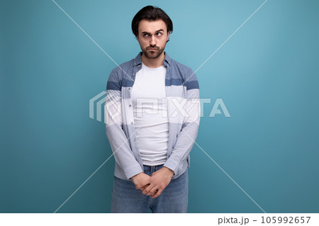 portrait of a well-groomed young brunette man on a studio background portrait of a well-groomed young brunette man on a studio background 105992657