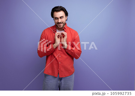 young european handsome guy with a stylish hairstyle folded his hands with a heart young european handsome guy with a stylish hairstyle folded his hands with a heart 105992735