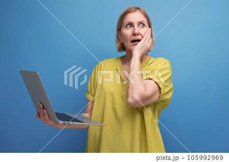 pensive middle aged business woman freelancing using laptop and internet connection 105992969