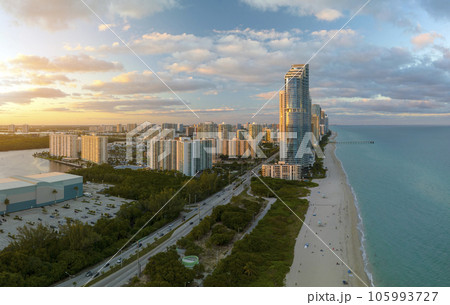 View from above of luxurious highrise hotels and condos on Atlantic ocean shore in Sunny Isles Beach city in the evening. American tourism infrastructure in southern Florida View from above of luxurious highrise hotels and condos on Atlantic ocean shore in Sunny Isles Beach city in the evening. American tourism infrastructure in southern Florida 105993727