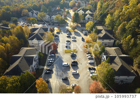 View from above of apartment residential condos between yellow fall trees in suburban area in South Carolina. American homes as example of real estate development in US suburbs 105993737