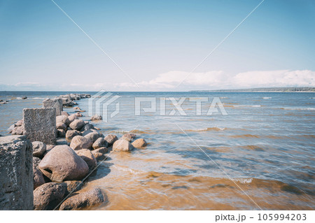 The sea bay and the old ruined pier on a sunny day 105994203