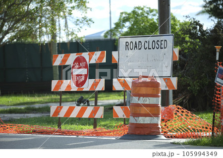 Road closed at construction site with protective fence barrier Road closed at construction site with protective fence barrier 105994349