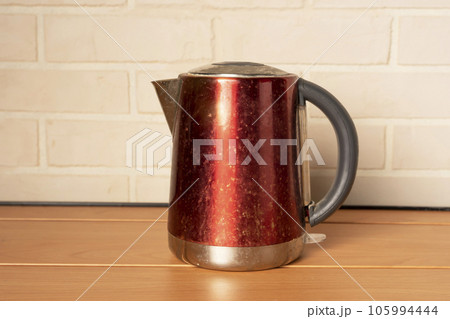 A broken old used electric kettle. Kitchen Accessories A broken old used electric kettle. Kitchen Accessories 105994444