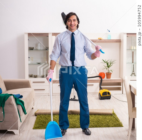 Young businessman cleaning the house 105994752