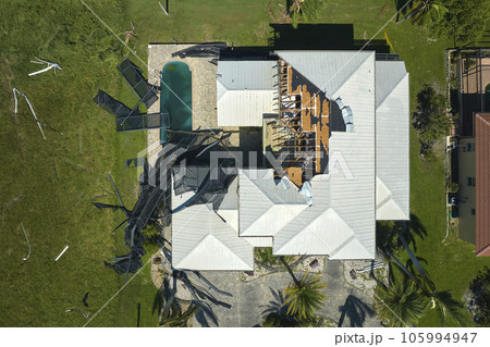 Hurricane Ian destroyed swimming pool lanai enclosure on house yard in Florida residential area. Natural disaster and its consequences Hurricane Ian destroyed swimming pool lanai enclosure on house yard in Florida residential area. Natural disaster and its consequences 105994947
