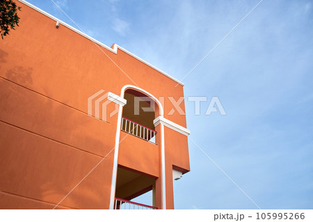 Fragment of red brick resort hotel exterior under blue summer sky 105995266