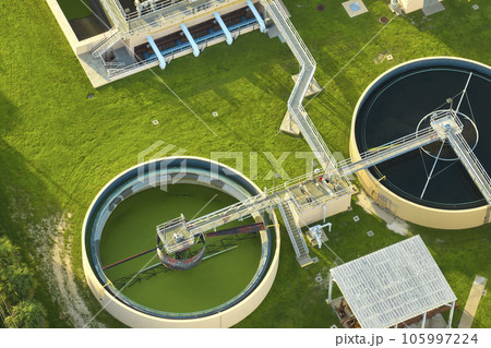 Aerial view of modern water cleaning facility at urban wastewater treatment plant. Purification process of removing undesirable chemicals, suspended solids and gases from contaminated liquid 105997224
