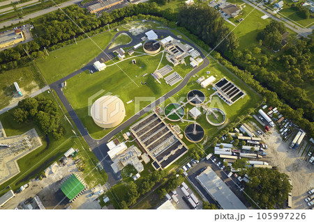 Aerial view of modern water cleaning facility at urban wastewater treatment plant. Purification process of removing undesirable chemicals, suspended solids and gases from contaminated liquid Aerial view of modern water cleaning facility at urban wastewater treatment plant. Purification process of removing undesirable chemicals, suspended solids and gases from contaminated liquid 105997226