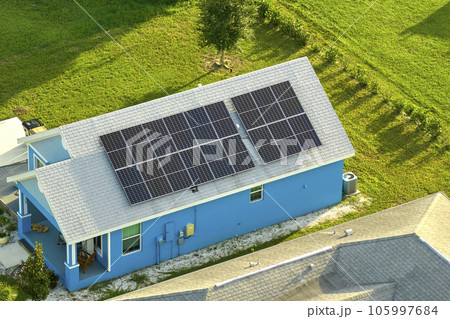 Aerial view building roof with rows of blue solar photovoltaic panels for producing clean ecological electric energy. Renewable electricity with zero emission concept 105997684