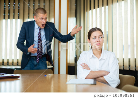 Emotional young boss berates his secretary girl in the conference room Emotional young boss berates his secretary girl in the conference room 105998561
