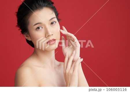 Beautiful young asian woman with clean fresh skin on red background, Face care, Facial treatment, Cosmetology, beauty and spa, Asian women portrait. 106003116