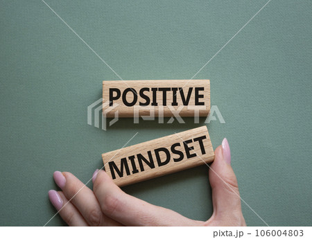 Positive Mindset symbol. Concept words Positive Mindset on wooden blocks. Businessman hand. Beautiful grey green background. Business and Positive Mindset concept. Copy space. 106004803