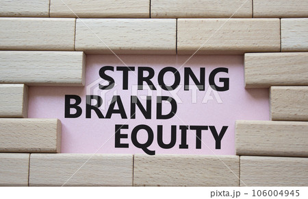 Strong Brand Equity symbol. Concept words Strong Brand Equity on wooden blocks. Beautiful pink background. Business and Strong Brand Equity concept. Copy space 106004945