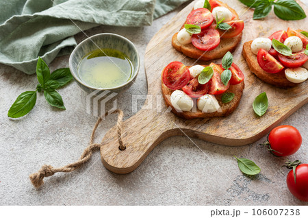 Bruschetta with tomato, basil and mozzarella cheese Bruschetta with tomato, basil and mozzarella cheese 106007238