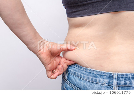 【わき腹の肉を摘む主婦の後ろ姿】 【わき腹の肉を摘む主婦の後ろ姿】 106011779