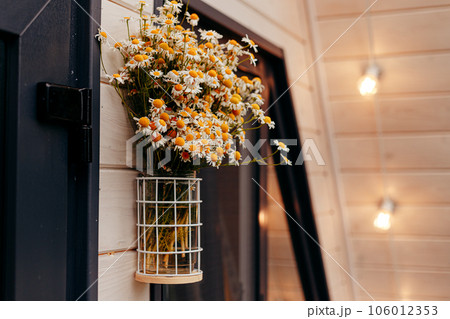 pot flowers hanging over the door with a sign that says "welcome". pot flowers hanging over the door with a sign that says "welcome". 106012353