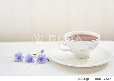 The composition of the drink from chicory, cups and saucers on a wooden table with space for copying. A healthy drink made from chicory. High quality photo 106013482