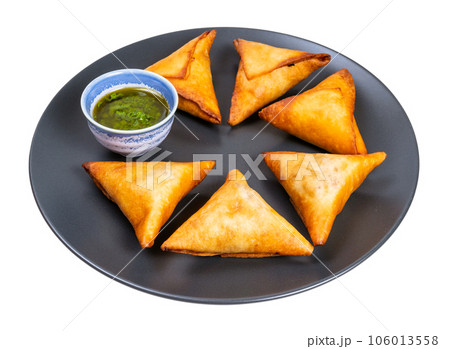 several triangular fried empanadas on black plate several triangular fried empanadas on black plate 106013558