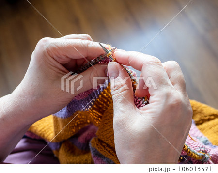 first-person view of hand knitting sweater closeup first-person view of hand knitting sweater closeup 106013571