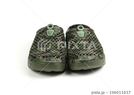 Pair dark green galoshes isolated on a white background. Shoes for rainy weather. Pair dark green galoshes isolated on a white background. Shoes for rainy weather. 106013837