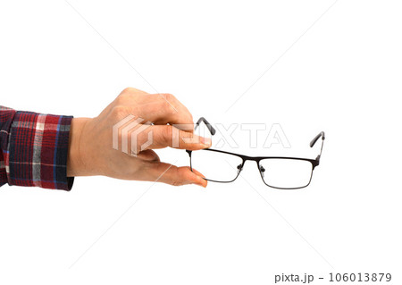 Hand holding plastic black glasses, isolated on white background. Hand holding plastic black glasses, isolated on white background. 106013879