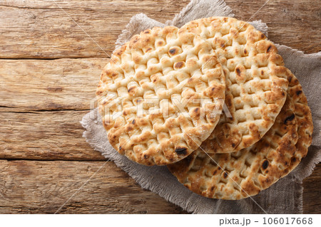 Homemade fresh round pita bread close-up on a table. Horizontal top view 106017668