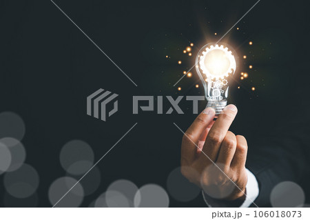 A businessman holding a light bulb, concept of creative thinking and innovation. inspiration and imagination in finding solutions. power of bright ideas and the energy bring to business and technology 106018073