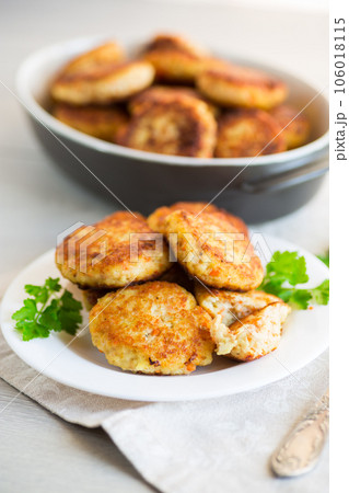 Cooked fried fish cutlets in a plate with herbs. 106018115