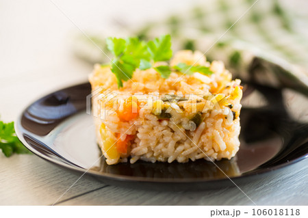 Cooked boiled rice with zucchini, carrots and vegetables in a plate 106018118