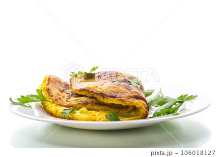 Fried omelette with zucchini,in a plate on a white background. 106018127