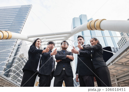 Group of multiethnic business team confident standing and showing thumbs up in urban 106018451