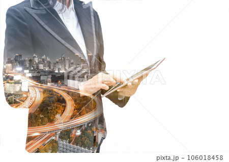 Businesswoman touching tablet with traffic on expressway in the city Businesswoman touching tablet with traffic on expressway in the city 106018458