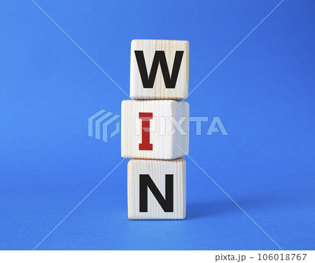Win symbol. Wooden blocks with words Win. Beautiful blue background. Business and Win concept. Copy space. Win symbol. Wooden blocks with words Win. Beautiful blue background. Business and Win concept. Copy space. 106018767