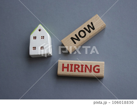 Now Hiring symbol. Concept word Now Hiring on wooden blocks. Beautiful grey background. Business and Now Hiring concept. Copy space 106018830