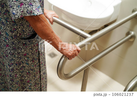 Asian elderly old woman patient use toilet support rail in bathroom, handrail safety grab bar, security in nursing hospital. Asian elderly old woman patient use toilet support rail in bathroom, handrail safety grab bar, security in nursing hospital. 106021237